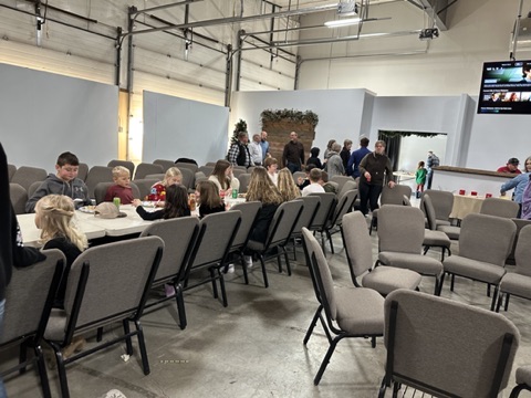 Tables set up for a shared meal in the fellowship hall after church