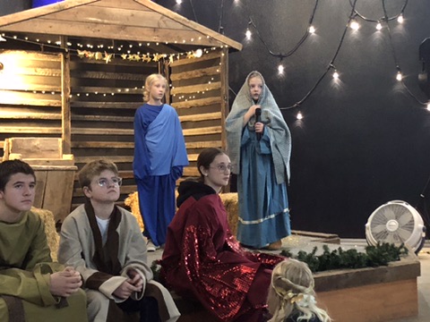 Children performing the annual Christmas nativity pageant on stage